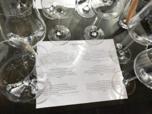 Wine glasses set up for a flight tasting at CheckMate